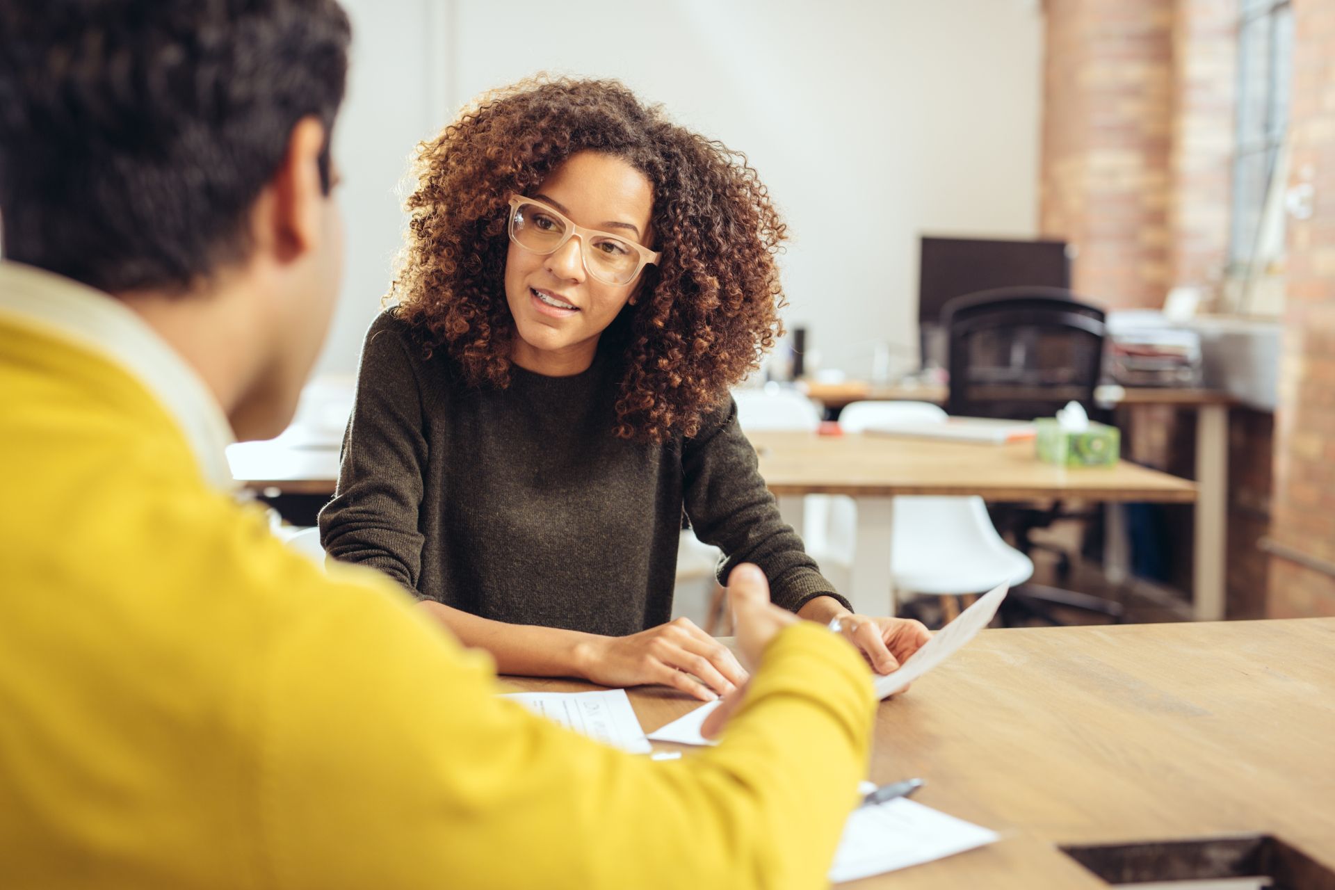 a woman talking to a man